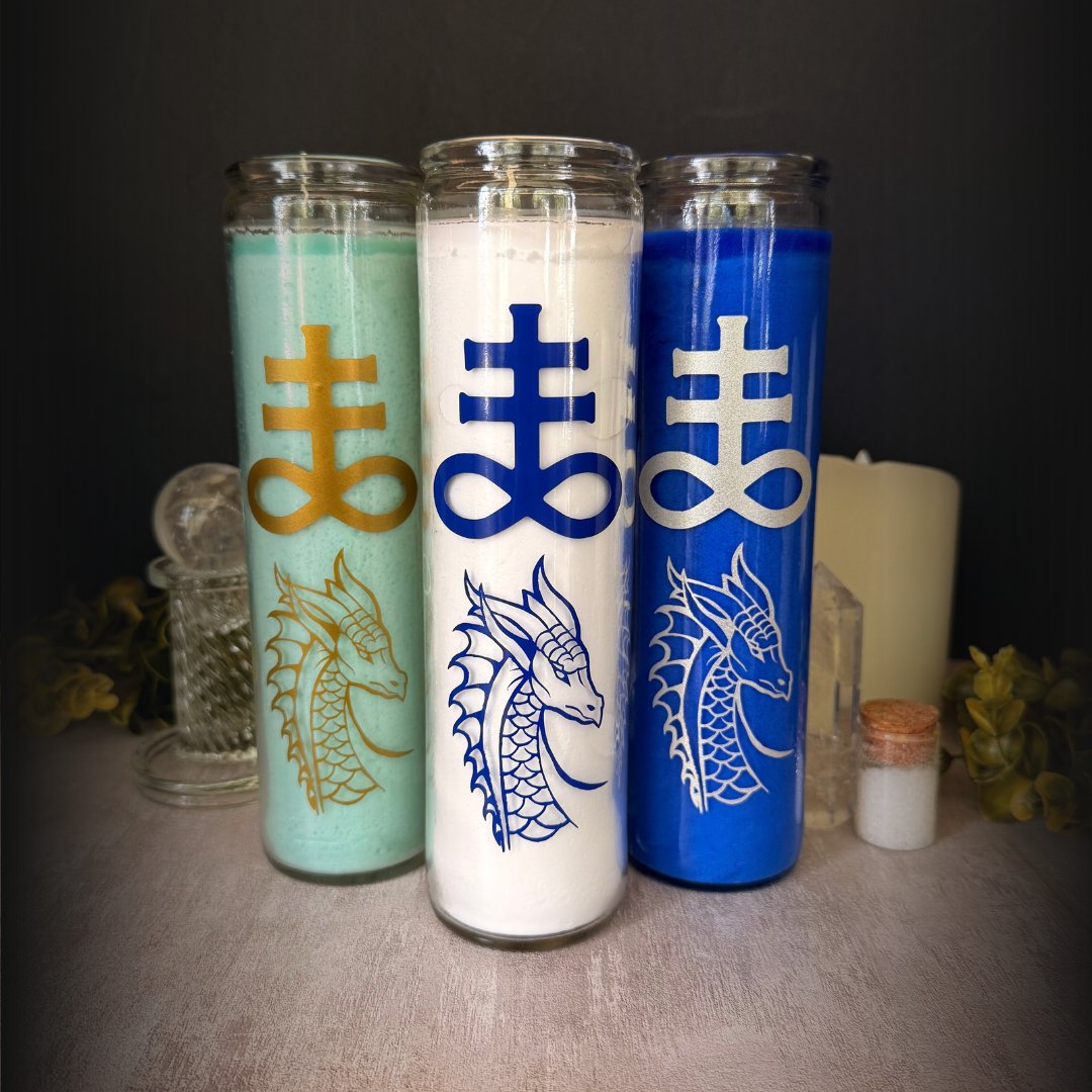 An aqua candle, a white candle, and a blue candle, each with a sea serpent and Leviathan symbol